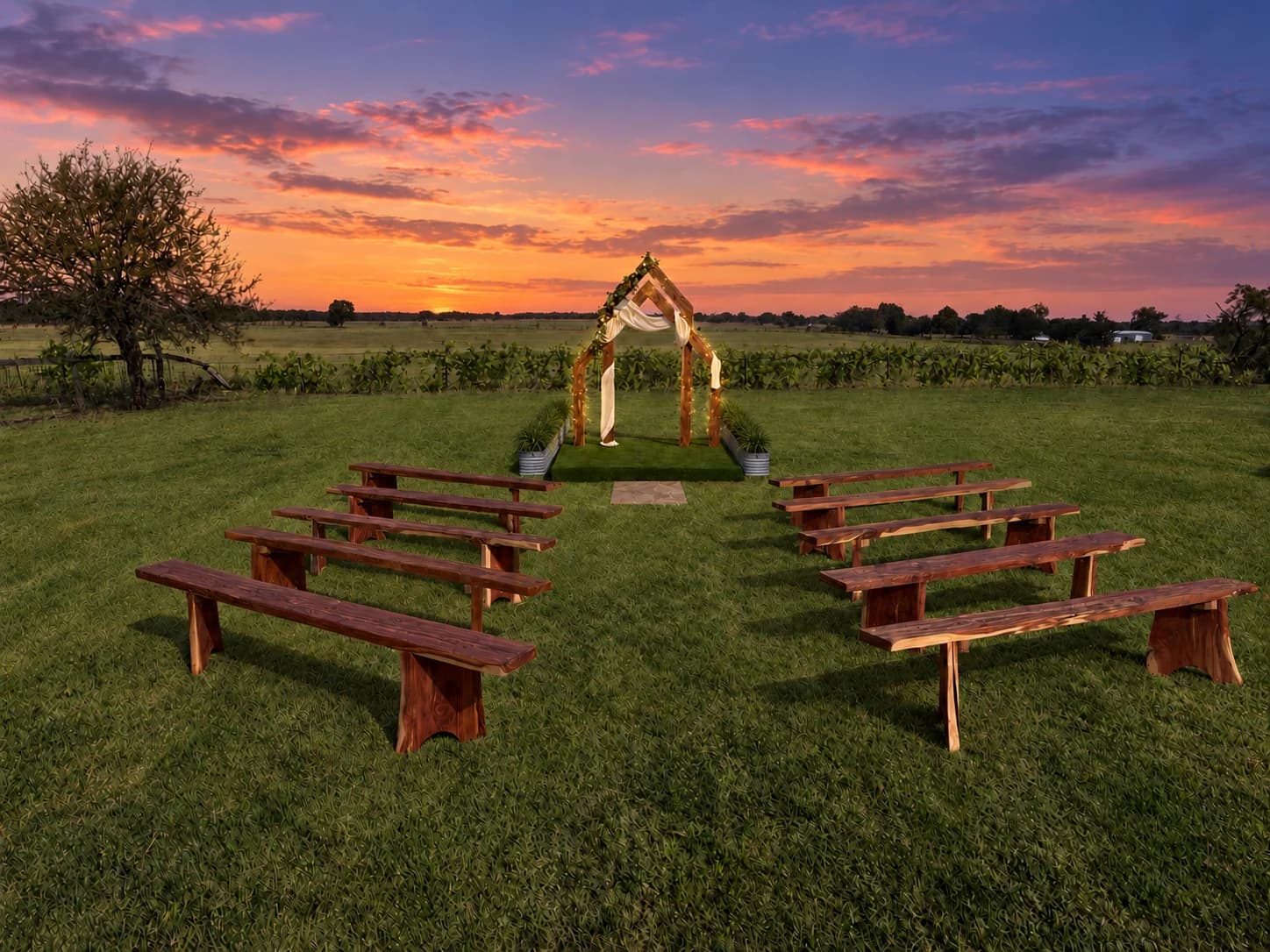 A wooden ceremony arbor and rows of benches on the lawn beneath a pink and orange Texas sunset